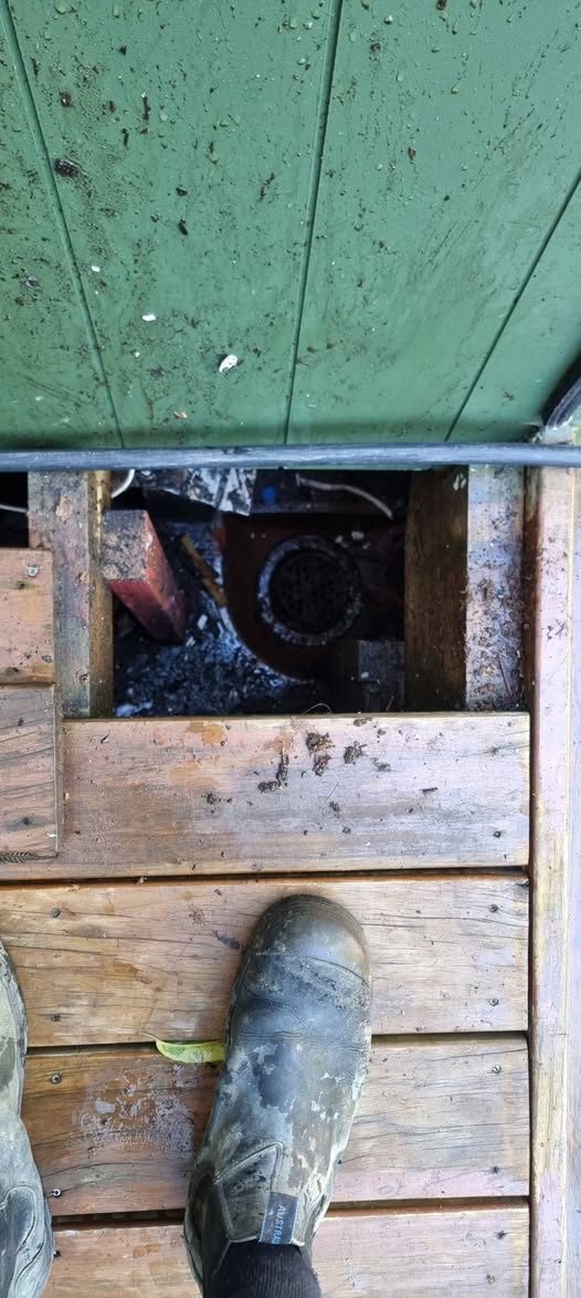 Exposed underground drain junction beneath lifted decking on an Upper Hutt drainage job